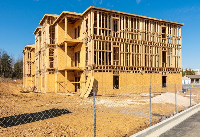 a temporary chain link fence in front of a building under construction, ensuring public safety in Danielsville, GA